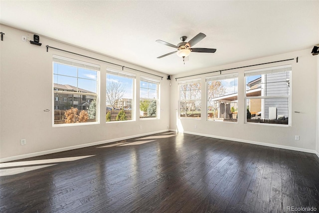 6370 Twilight Ave, Firestone, CO 80504 - unfurnished living room with dark wood-style flooring, a ceiling fan, and baseboards