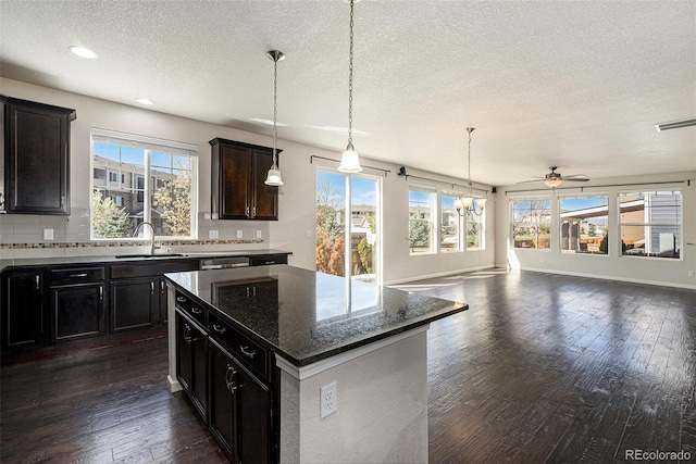6370 Twilight Ave, Firestone, CO 80504 - kitchen featuring a textured ceiling, plenty of natural light, a sink, a center island, and ceiling fan