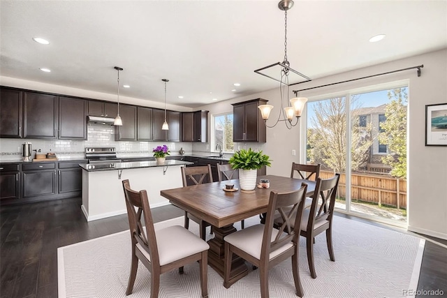 6370 Twilight Ave, Firestone, CO 80504 - dining space with dark wood-style flooring, recessed lighting, and a chandelier
