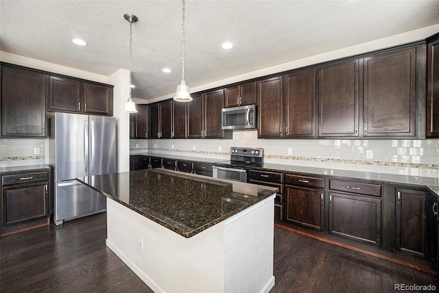 6370 Twilight Ave, Firestone, CO 80504 - kitchen with appliances with stainless steel finishes, dark brown cabinetry, dark wood-type flooring, dark stone countertops, and backsplash