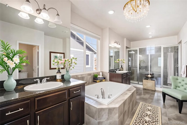 6370 Twilight Ave, Firestone, CO 80504 - bathroom featuring vanity, a stall shower, a garden tub, a chandelier, and recessed lighting