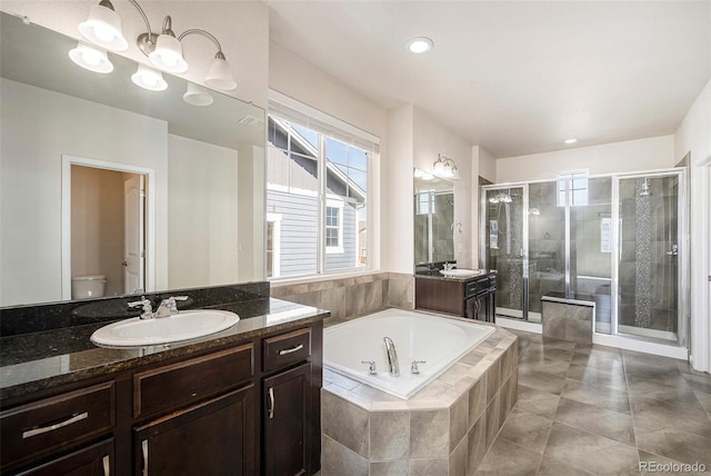 6370 Twilight Ave, Firestone, CO 80504 - bathroom featuring vanity, a shower stall, toilet, a garden tub, and healthy amount of natural light