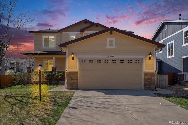 6370 Twilight Ave, Firestone, CO 80504 - view of front of house with stone siding, concrete driveway, and a garage