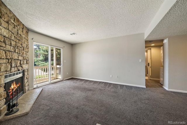 1970 S Xanadu Way Unit 101, Aurora, CO 80014 - unfurnished living room featuring a textured ceiling, a fireplace, and carpet floors