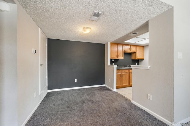 1970 S Xanadu Way Unit 101, Aurora, CO 80014 - kitchen with light carpet, a textured ceiling, and a wall mounted AC