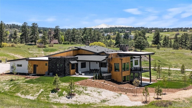 11115 Evening Hunt Rd, Franktown, CO 80116 - back of house with a patio