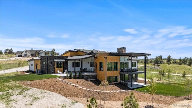 11115 Evening Hunt Rd, Franktown, CO 80116 - back of house featuring a patio, a chimney, and a yard