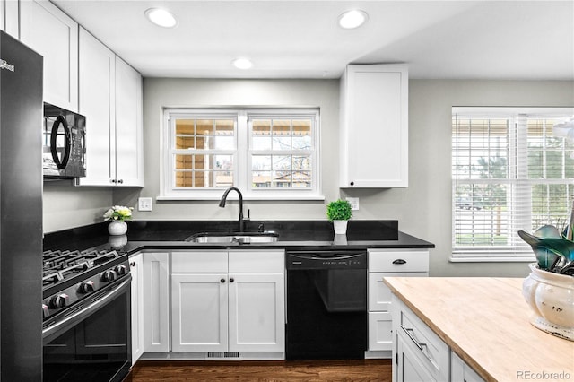 1765 S Endicott St, Lakewood, CO 80232 - kitchen featuring black appliances, a sink, white cabinetry, recessed lighting, and dark wood-type flooring