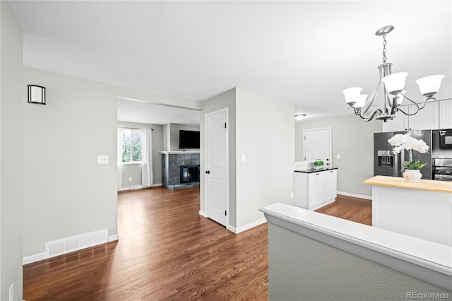 1765 S Endicott St, Lakewood, CO 80232 - kitchen featuring stainless steel fridge with ice dispenser, dark wood-type flooring, black microwave, and a chandelier