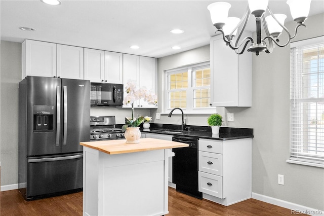 1765 S Endicott St, Lakewood, CO 80232 - kitchen with black appliances, wood counters, a sink, a chandelier, and white cabinets