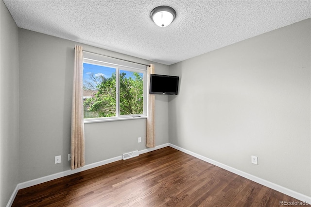1765 S Endicott St, Lakewood, CO 80232 - spare room with a textured ceiling, wood finished floors, and baseboards