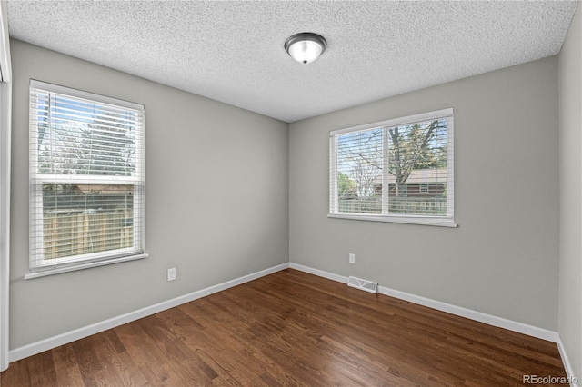 1765 S Endicott St, Lakewood, CO 80232 - unfurnished room featuring wood finished floors, baseboards, and a textured ceiling