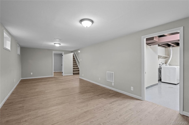 1765 S Endicott St, Lakewood, CO 80232 - finished basement featuring washer and clothes dryer, stairs, light wood-style floors, and baseboards