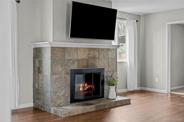 1765 S Endicott St, Lakewood, CO 80232 - detailed view of a tile fireplace, wood finished floors, and baseboards