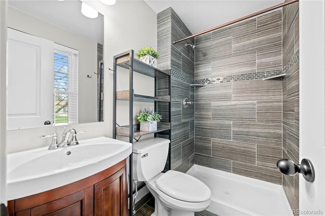 1765 S Endicott St, Lakewood, CO 80232 - bathroom with tiled shower, vanity, and toilet