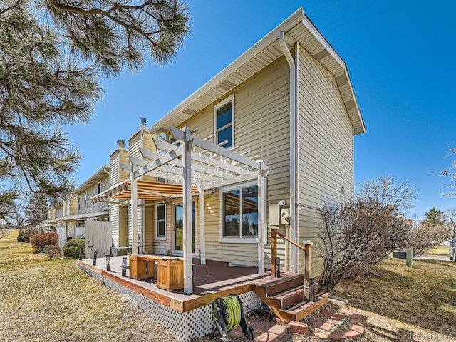 rear view of property with a chimney, a deck, and a pergola