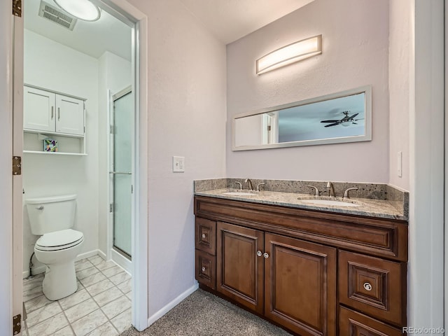 full bath featuring toilet, a sink, visible vents, and a shower stall