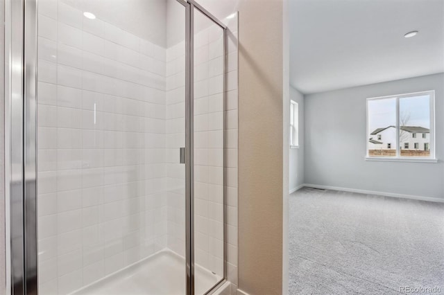 bathroom with a shower with door