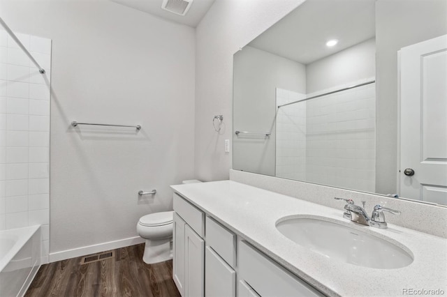 bathroom with hardwood / wood-style floors, vanity, and toilet