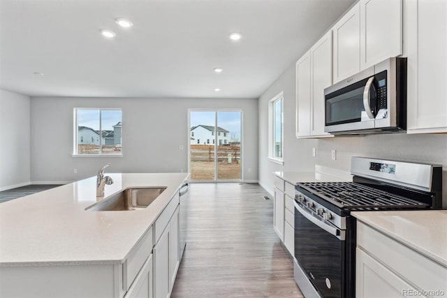 kitchen featuring white cabinetry, a kitchen island with sink, and stainless steel appliances