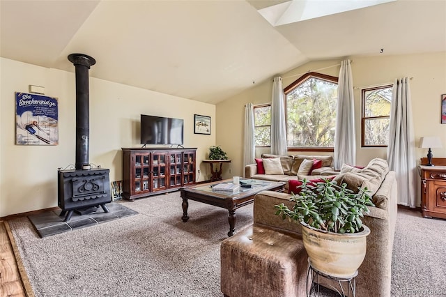 carpeted living area featuring vaulted ceiling and a wood stove