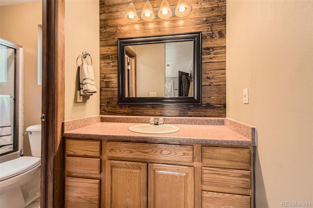 bathroom featuring vanity, toilet, and a shower