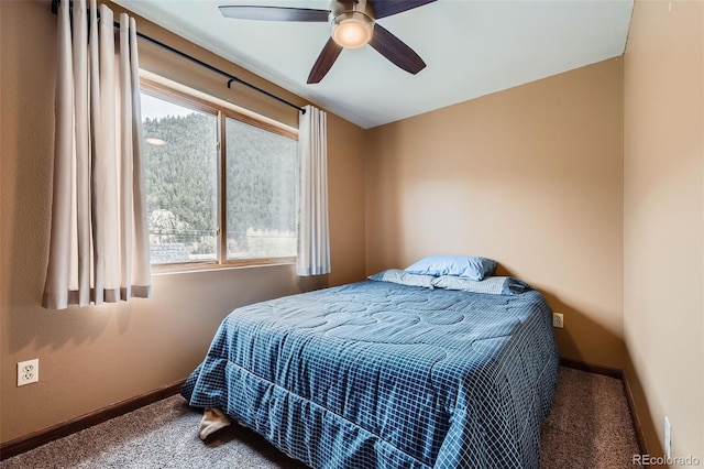 carpeted bedroom with multiple windows, baseboards, and ceiling fan