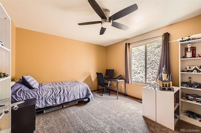 carpeted bedroom with ceiling fan and baseboards