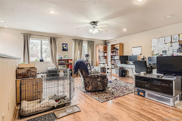 living room featuring a ceiling fan, wood finished floors, recessed lighting, and a desk