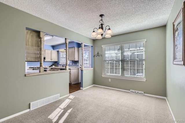 interior space with carpet flooring, sink, a textured ceiling, and a chandelier