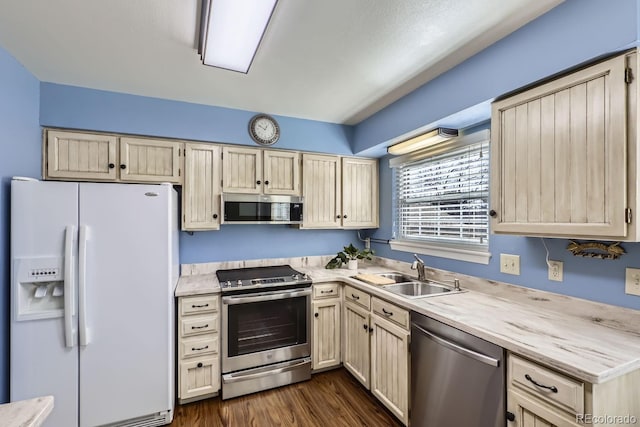 kitchen featuring dark hardwood / wood-style flooring, sink, stainless steel appliances, and light brown cabinets