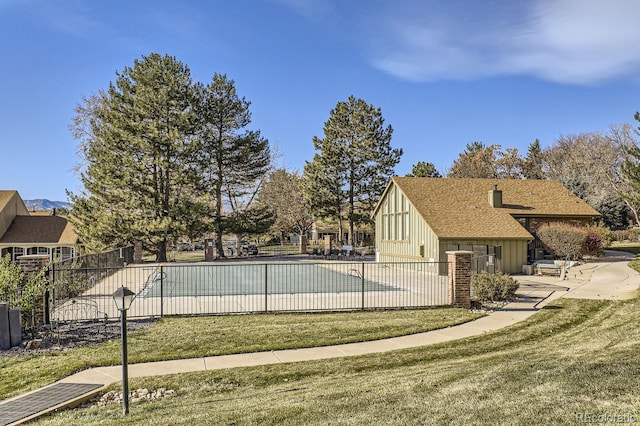 view of swimming pool with a yard and a patio