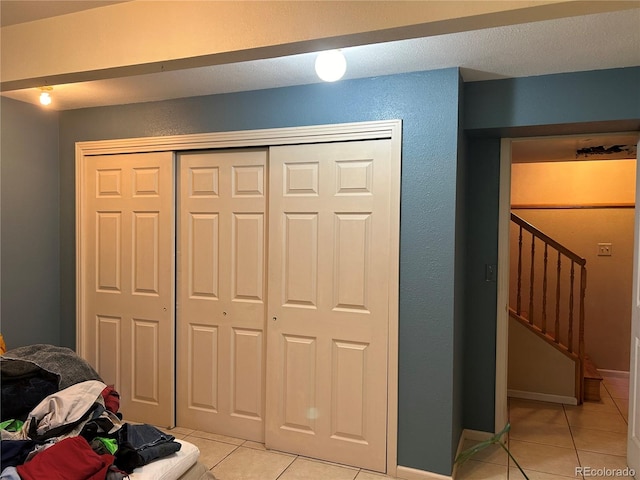 bedroom featuring a closet and light tile patterned floors