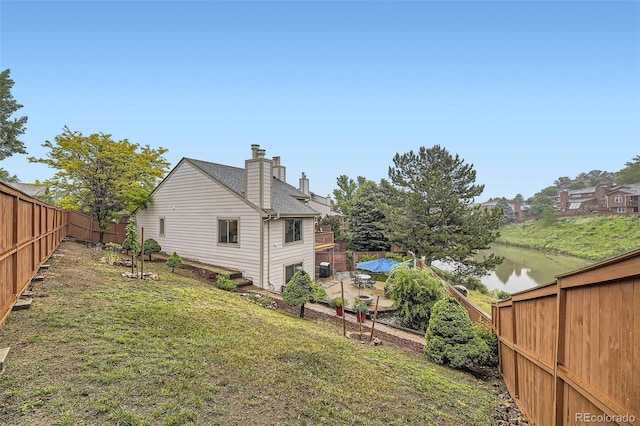 12668 W 1st Pl Unit 81, Denver, CO 80228 - back of house featuring a chimney and a water view