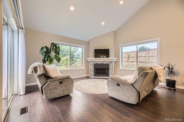 12668 W 1st Pl Unit 81, Denver, CO 80228 - living area featuring a fireplace with flush hearth, baseboards, wood-type flooring, high vaulted ceiling, and recessed lighting