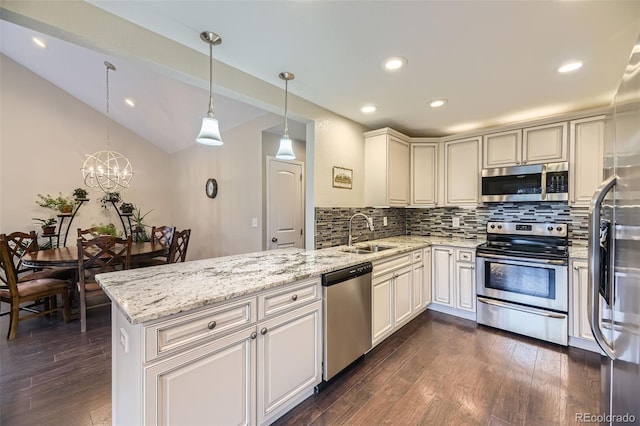 12668 W 1st Pl Unit 81, Denver, CO 80228 - kitchen with stainless steel appliances, a peninsula, a sink, backsplash, and dark wood-style floors