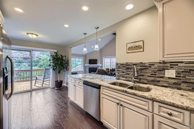 12668 W 1st Pl Unit 81, Denver, CO 80228 - kitchen with appliances with stainless steel finishes, a sink, vaulted ceiling, decorative backsplash, and dark wood-style floors
