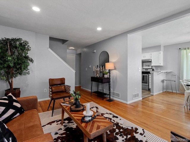 1714 W 102nd Ave, Thornton, CO 80260 - living room with light wood-type flooring, recessed lighting, and stairs
