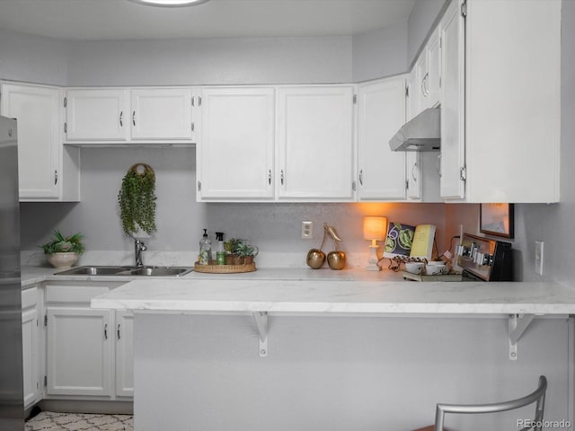 1714 W 102nd Ave, Thornton, CO 80260 - kitchen with extractor fan, white cabinets, and light stone counters