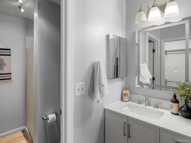 1714 W 102nd Ave, Thornton, CO 80260 - bathroom featuring vanity and wood finished floors