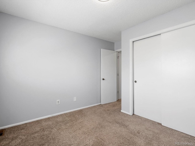 1714 W 102nd Ave, Thornton, CO 80260 - unfurnished bedroom featuring carpet, a closet, and a textured ceiling