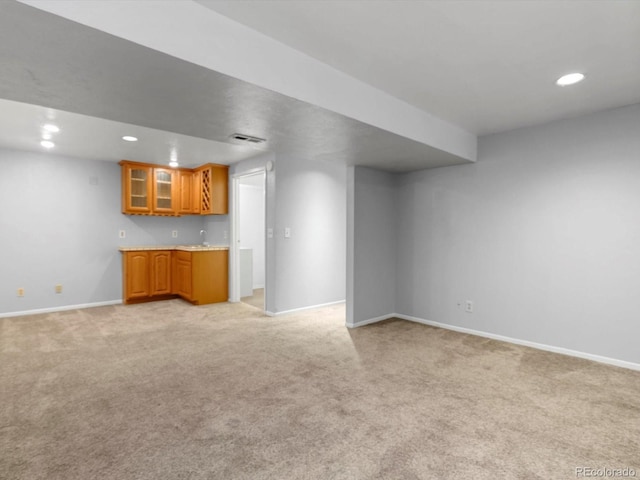 1714 W 102nd Ave, Thornton, CO 80260 - unfurnished living room with light colored carpet, recessed lighting, and bar