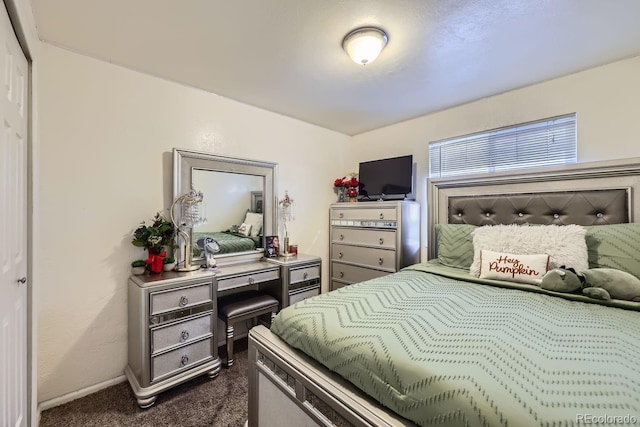 bedroom featuring dark colored carpet