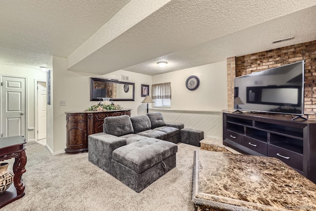 living room featuring a textured ceiling, wooden walls, and carpet