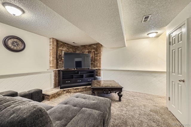 carpeted living room featuring a textured ceiling