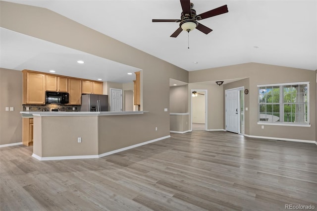8258 S Sicily Ct, Aurora, CO 80016 - kitchen featuring black microwave, stainless steel fridge, a ceiling fan, vaulted ceiling, and light wood-style floors