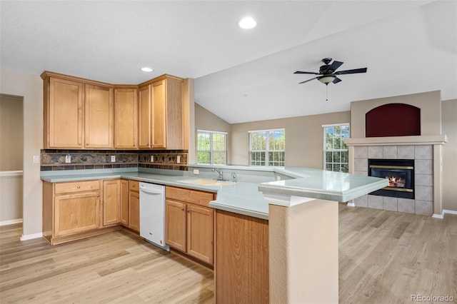 8258 S Sicily Ct, Aurora, CO 80016 - kitchen featuring white dishwasher, a peninsula, light wood-style floors, a sink, and vaulted ceiling