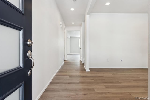 foyer entrance with recessed lighting, baseboards, and light wood-style floors