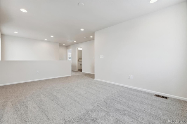 carpeted empty room with recessed lighting, visible vents, and baseboards