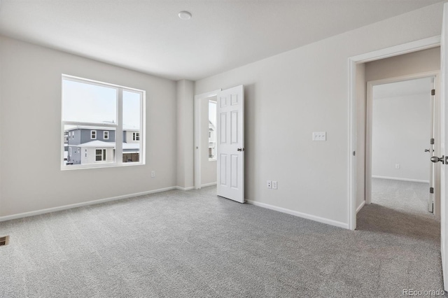 empty room with visible vents, baseboards, and carpet floors